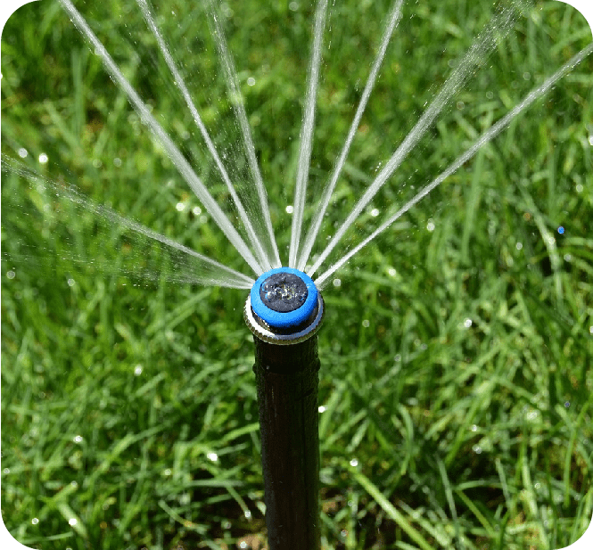 A close up of the water spiking from a garden hose